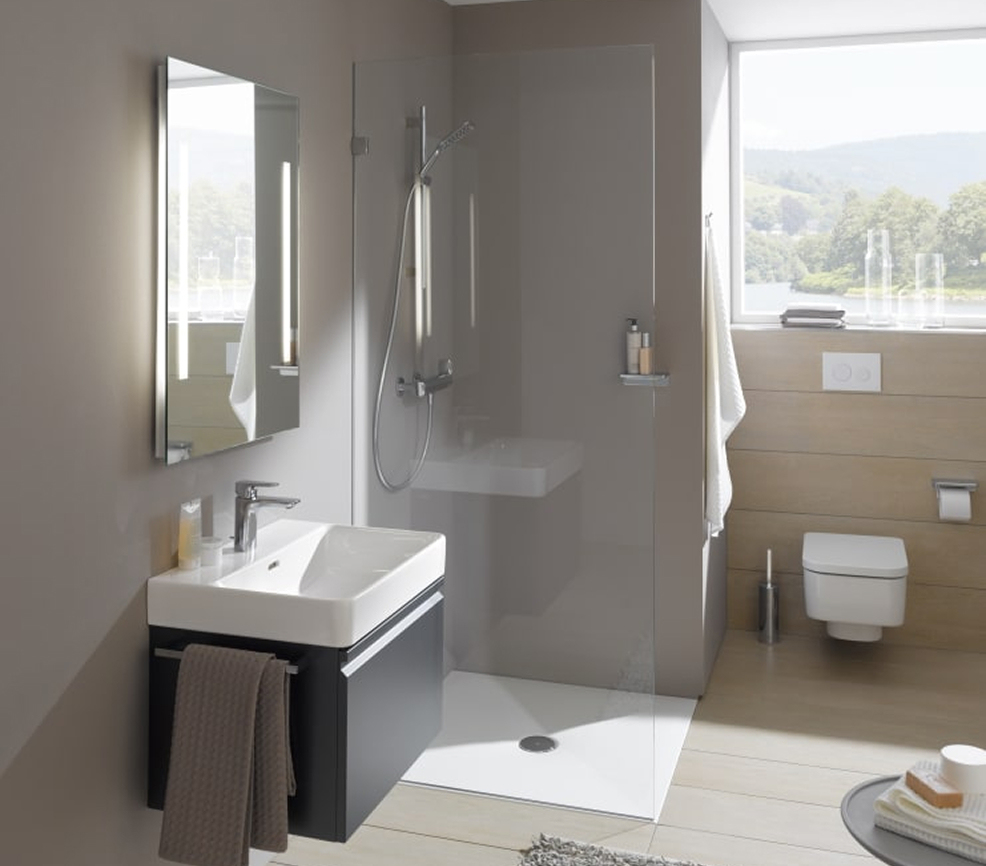 Modern bathroom with a glass-walled shower, wall-mounted white sink on a dark vanity, and a window offering a countryside view.
