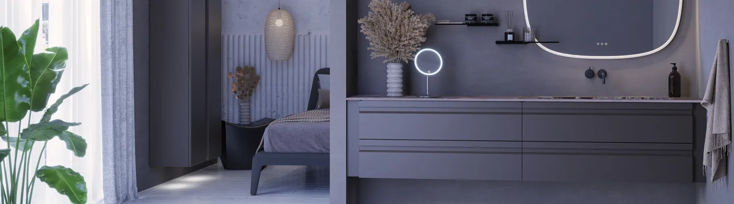 Modern grey bathroom with a long dark vanity and marble top, circular LED mirror, shelves and towel; bed area with dried plant seen in the background.