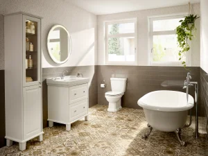Bright vintage bathroom with white vanity and sink, mirror, tall cabinet, toilet, clawfoot tub, and a hanging plant by the window.