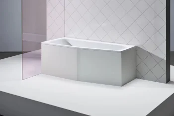 Minimalist white rectangular bathtub on a white platform, set against a diamond-pattern tiled wall with a translucent pink glass panel.