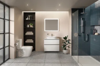 Contemporary bathroom with grey tiled floor, wall-mounted white vanity and backlit square mirror, open shelving with towels, toilet, a potted plant, and a glass-walled blue-tiled shower.