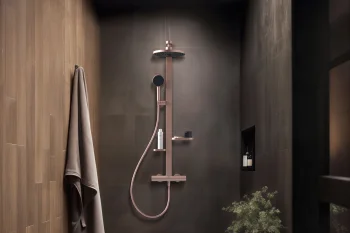 Luxurious shower with dark tiles and rose-gold fixtures, rainfall head and handheld wand, built-in niche, towel on wooden wall, plant on a wooden stump.