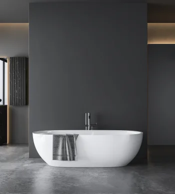 Minimalist dark-grey bathroom with a white freestanding tub and chrome taps. Grey towel over tub; left windows and a walk-in shower.