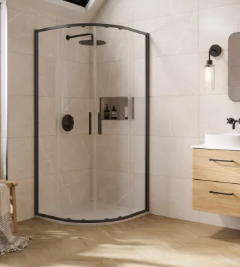 Bright modern bathroom with a curved glass shower enclosure, a wooden double vanity, large mirror, wall sconce, and a frosted window.