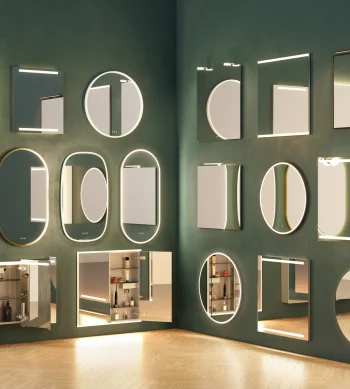 A green wall displaying a variety of backlit mirrors in different shapes—rectangles, circles and ovals—some with shelves or cabinets.