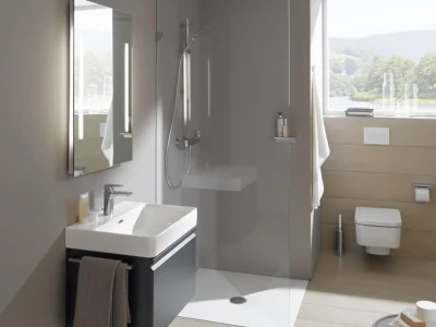 Modern bathroom with a glass-walled shower, wall-mounted white sink on a dark vanity, and a window offering a countryside view.