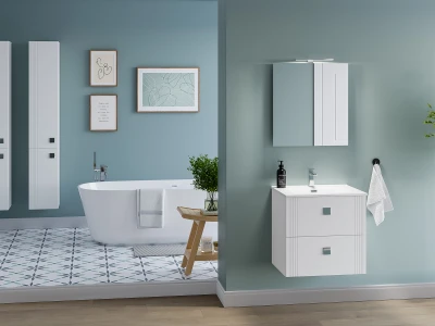 Split bathroom: left freestanding white tub with towel against teal walls and art; right white vanity with mirror cabinet and towel.