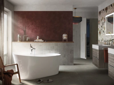 Modern bathroom with a white freestanding tub set against a burgundy accent wall, a tiled low partition, and wooden double basins beneath floral wallpaper.