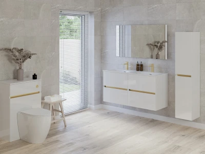 Modern bathroom with a white floating double vanity, gold hardware, wall mirror, grey tiled walls, light wood floor, blinds, vase of dried flowers.