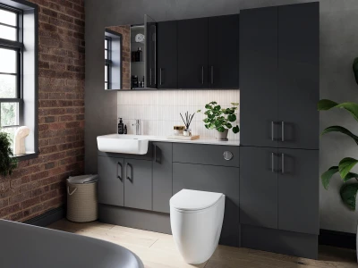 Modern bathroom with dark grey cabinetry, white sink and toilet, white tiled splashback, brick wall and a large window, plus a potted plant on the counter.