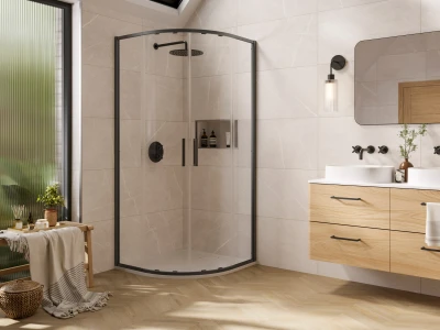 Bright modern bathroom with a curved glass shower enclosure, a wooden double vanity, large mirror, wall sconce, and a frosted window.