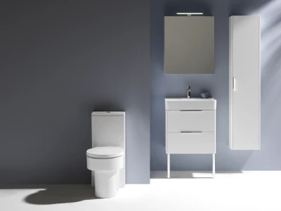 Minimalist bathroom with a white toilet, white sink vanity with drawers, a tall white cabinet, and a square mirror above; blue walls.