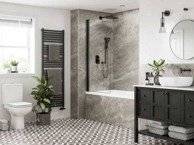 Modern bathroom with white walls, black vanity, round mirror, white basin, glass shower enclosure, marble walls, patterned floor, toilet, and plants.