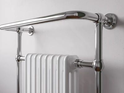Chrome-plated radiator with vertical fins and curved wall pipework mounted on a white textured wall.