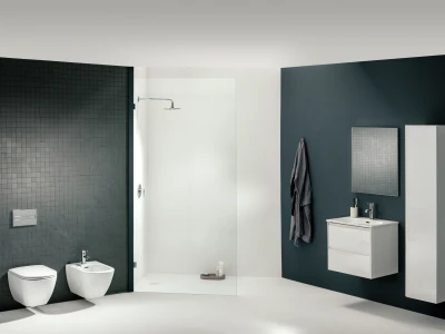 Modern bathroom with a dark tile wall, white toilet and bidet, glass shower enclosure, and a white wall-mounted vanity with a mirror on a dark blue wall.