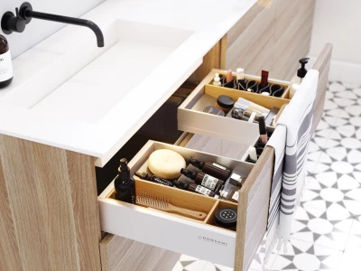 Vanity with white countertop, black faucet and cabinet; drawers hold makeup, brushes and bottles, with a striped towel and geometric floor tiles.