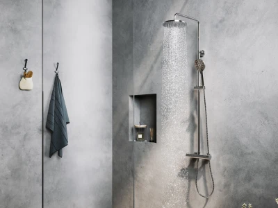 Grey concrete bathroom with chrome rainfall shower, handheld shower on a vertical rail, recessed shelf with candle, towel on a hook, and green plants.