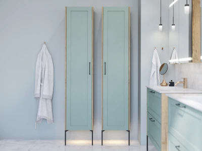A modern bathroom with two mint-green tall cabinets, a grey robe on a wall hook, and a marble-topped vanity with a gold faucet.