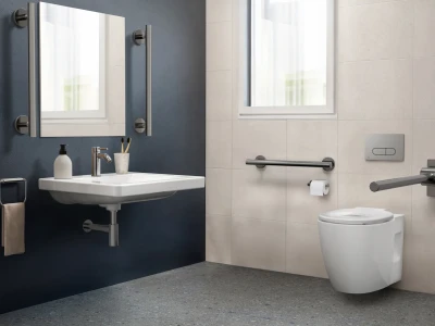 Contemporary bathroom with a wall-mounted white sink and chrome faucet on a dark blue wall; beige tiled wall with a wall-mounted toilet, grab bars, and a window.