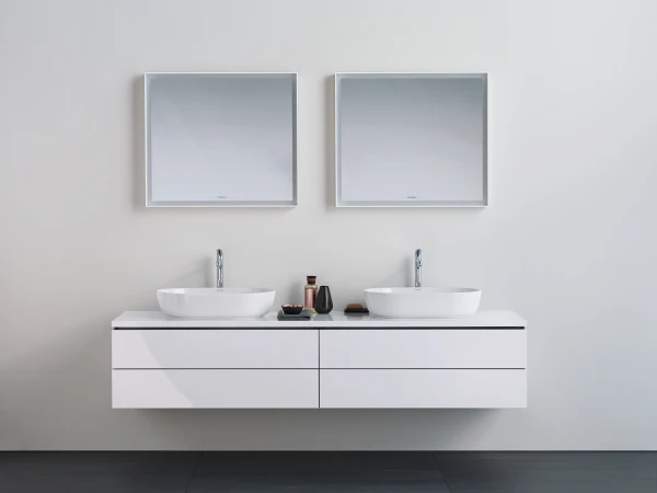 Minimalist bathroom with a floating white double vanity, two square-framed mirrors, light grey walls, and white vessel sinks with chrome taps.