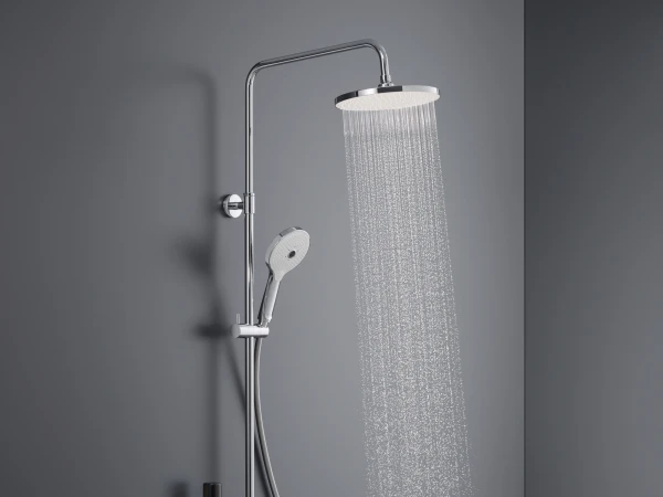 Chrome shower system on a grey wall, featuring a rain shower head, a handheld wand, and a wall-mounted control panel; shelf holds bottle and sponge.