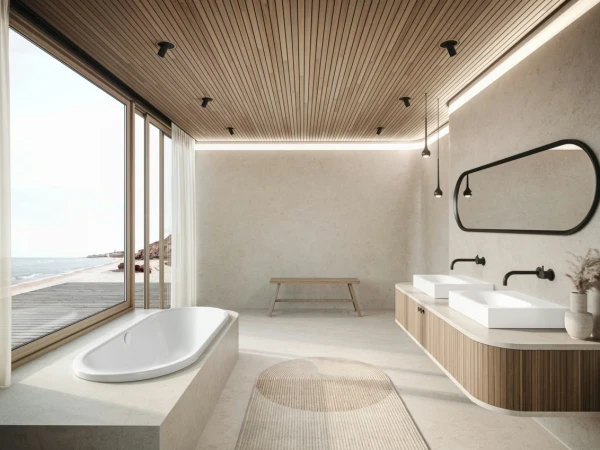 Bright modern bathroom with sea view: oval tub by a large window, double square sinks on a wood vanity, rounded mirror and pendant lights.