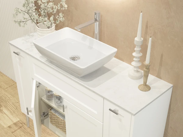 White bathroom vanity with a rectangular vessel sink and marble countertop; vase of white flowers, candles, and an open cabinet with a woven basket.