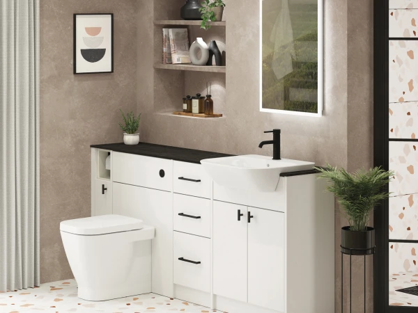 Contemporary bathroom with white base cabinets, a black countertop and basin, black tap, beige textured walls, shelves with decor, framed art and a potted plant.